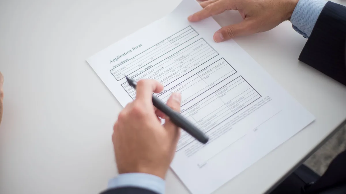 Person reviewing an application form at a desk