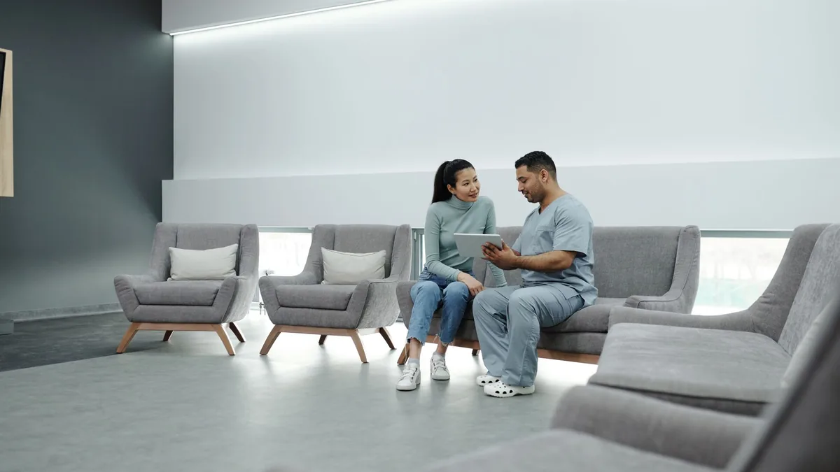 Doctor talking with a patient in a clinic waiting area