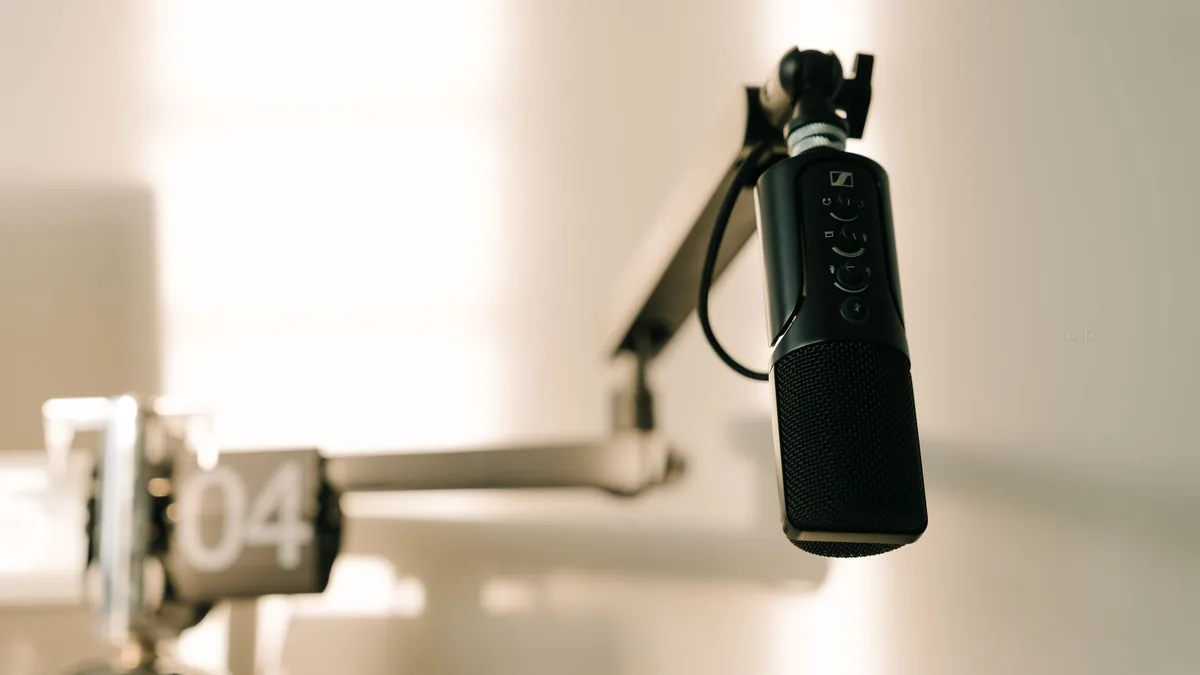 Studio microphone on a boom arm, ready to record a podcast