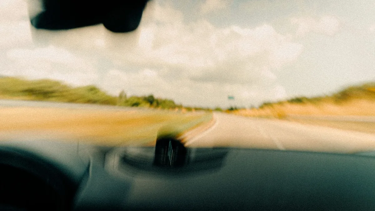 View through a car windscreen of an open country road