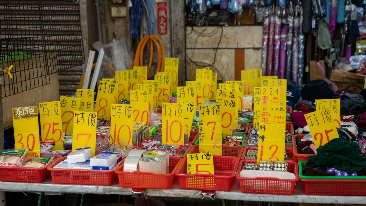 Market stall full of goods with bright yellow price tags