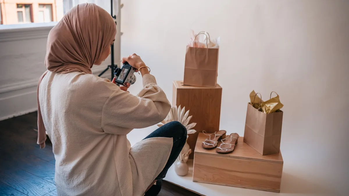 Woman photographing products for an online shop in a bright studio