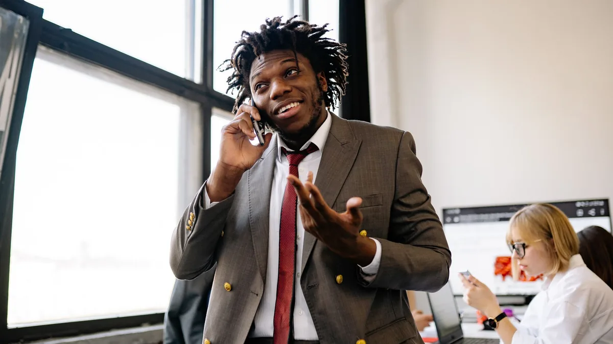 Smiling businessman talking on the phone in an office