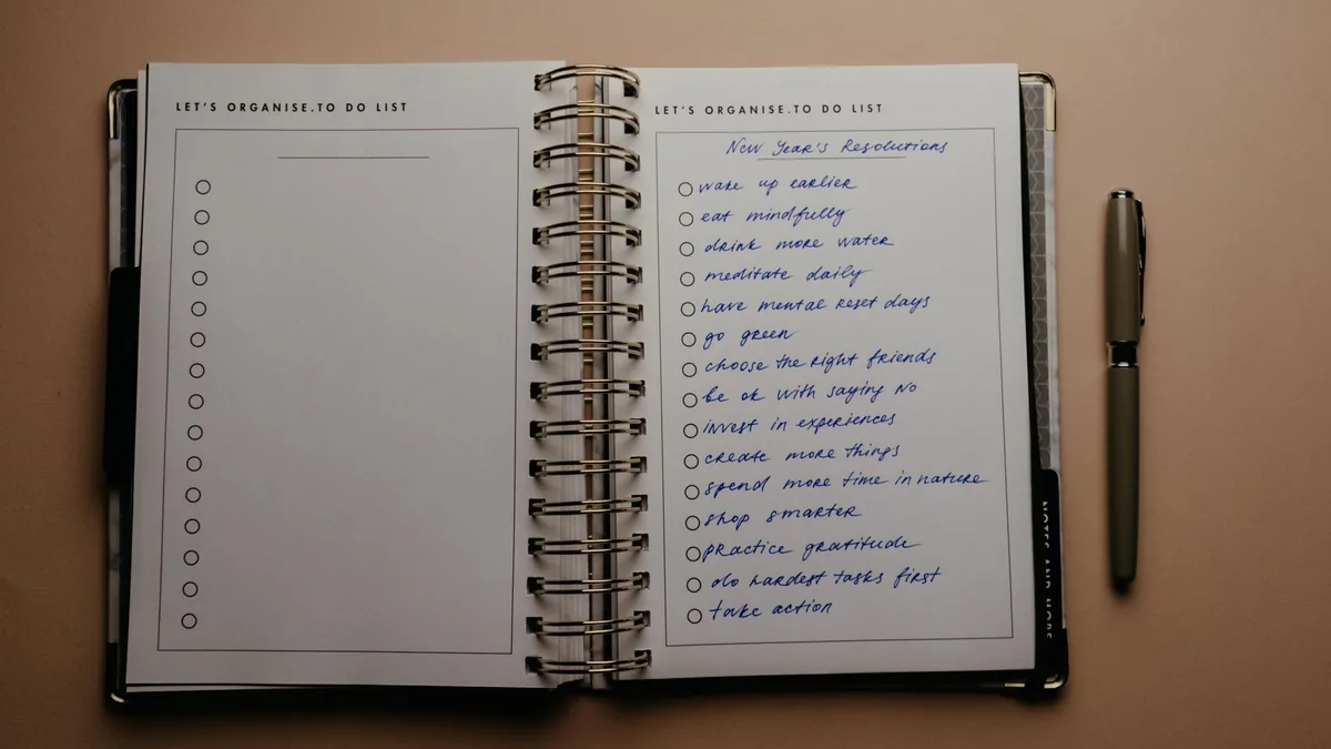 Open planner with a handwritten list and a pen