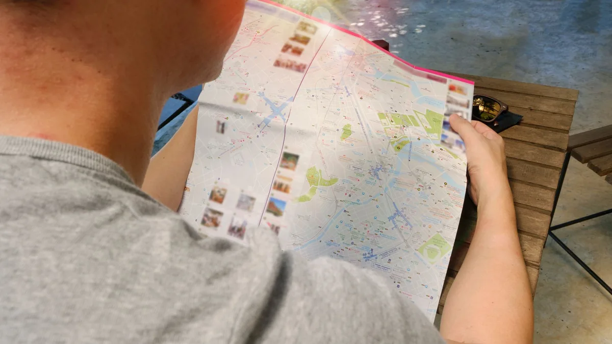 Traveller studying a paper map for directions